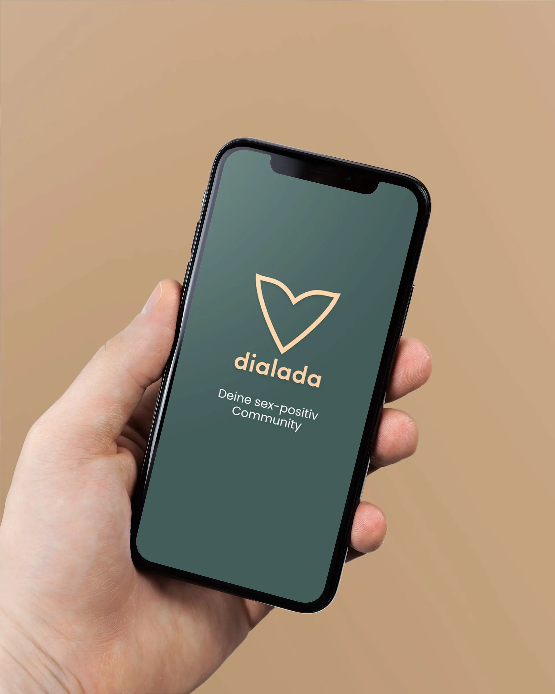 Hand holding a smartphone showing the dialada start screen: heart logo on dark green