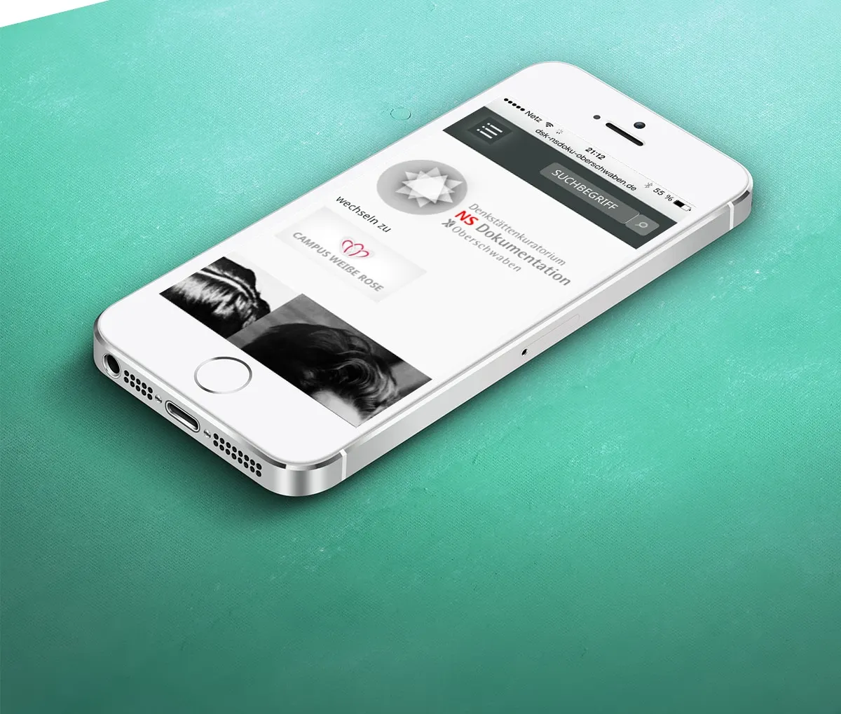 Mobile view of the website on a smartphone against a turquoise background